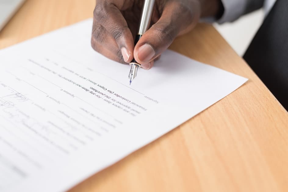 First-time buyer completing mortgage preapproval paperwork at a desk
